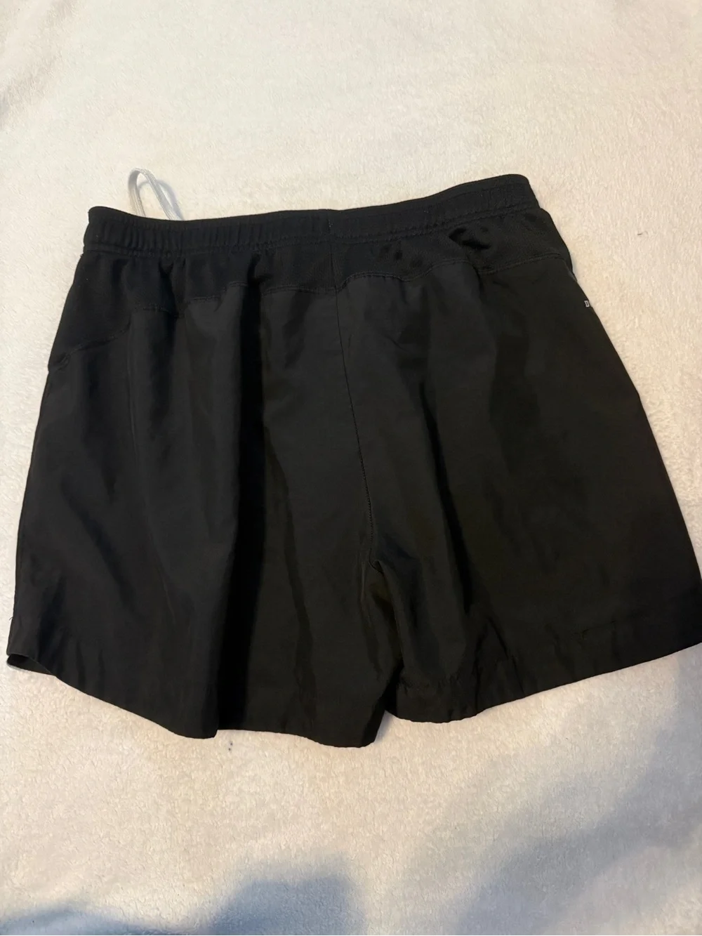 Nike Black Athletic Running Shorts with White Accents and Yellow Number